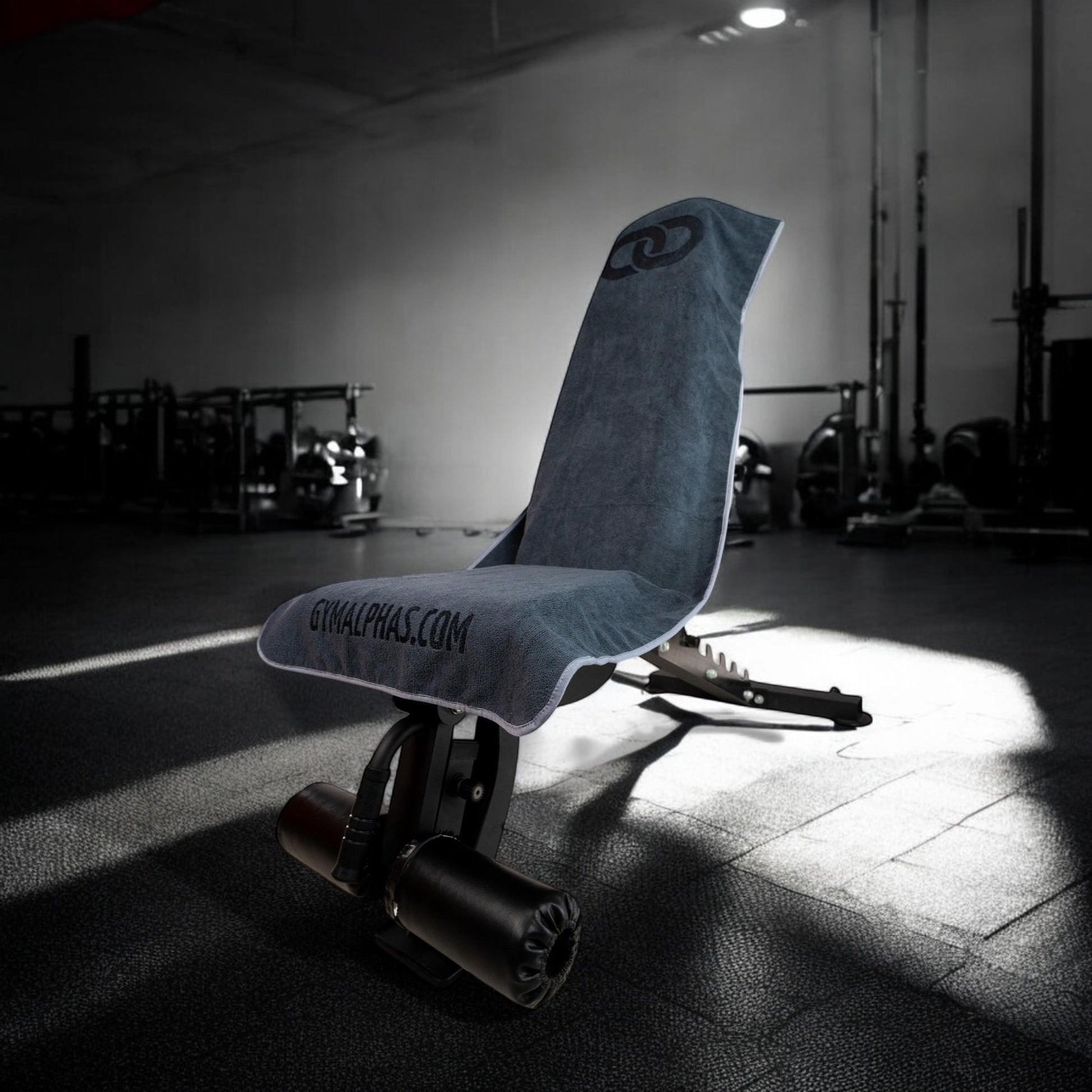 Multi-functional hooded gym towel on a workout bench, showcasing full coverage design and magnetic hanger feature.
