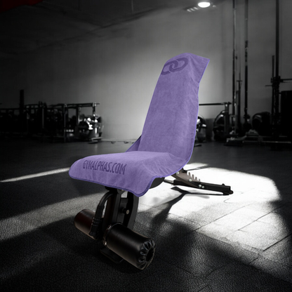 Hooded gym towel in purple covering a gym bench, showcasing premium water absorbent and quick-dry features.